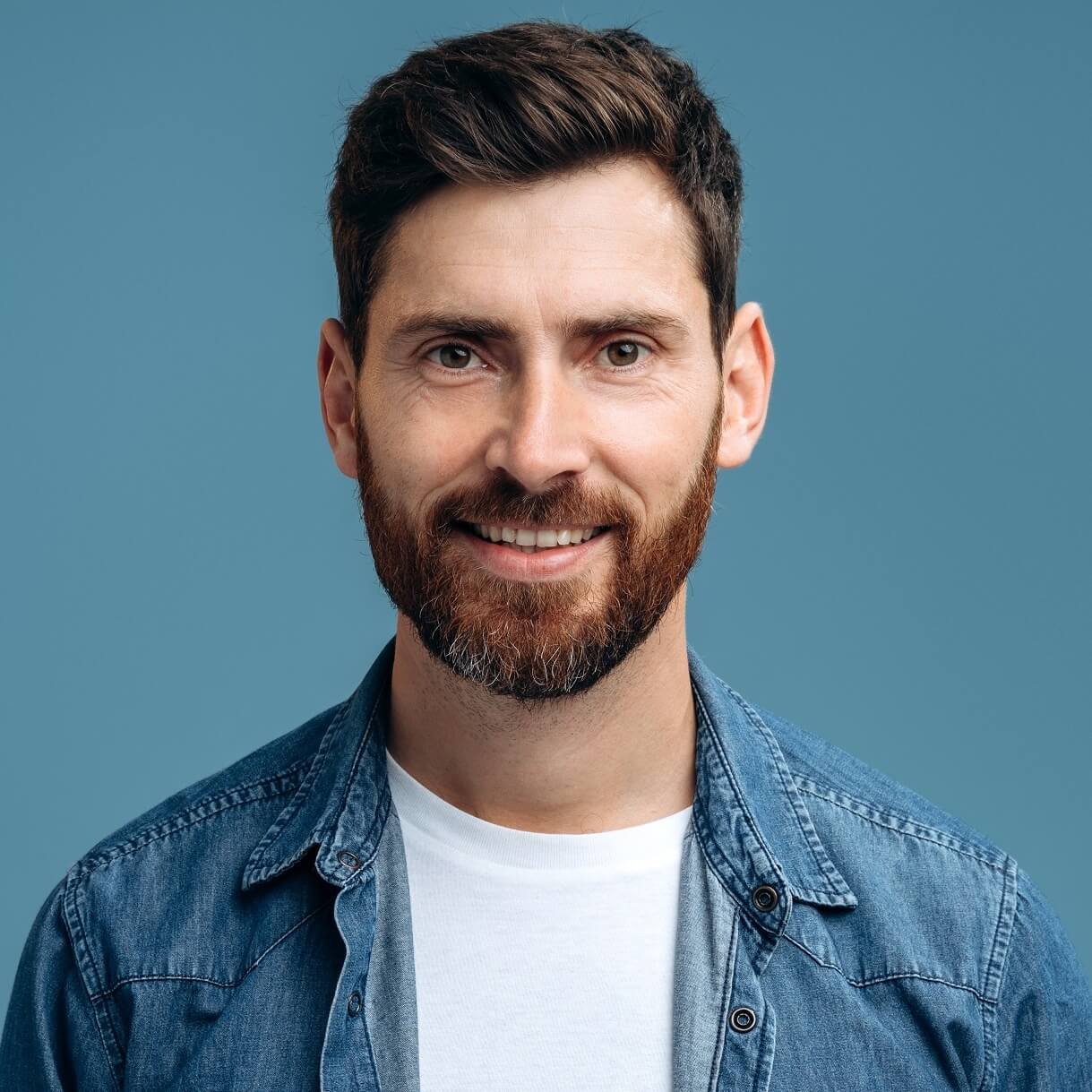 portrait-of-cheerful-handsome-man-in-denim-shirt-s-ZXG9M4Pjpg - Grasshopper